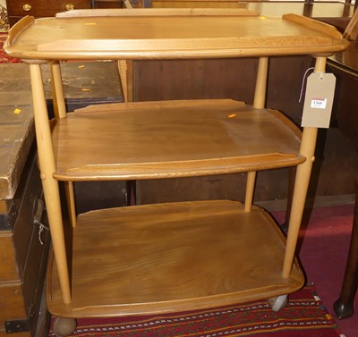 Lot 1360 - An Ercol blond elm and beech three-tier tea...