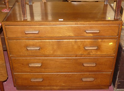 Lot 1364 - A utility oak square front chest of four long...
