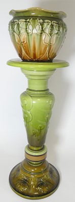 Lot 419 - A Bretby green glazed pottery jardinere stand,...