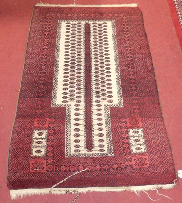 Lot 1168 - A Persian red and cream ground woollen prayer...