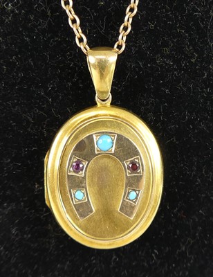 Lot 2324 - A yellow metal oval locket, having raised...