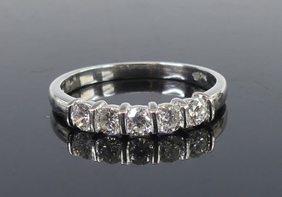 Lot 2645 - A platinum diamond half eternity ring,...