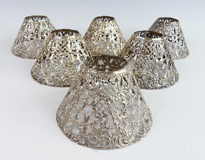 Lot 2219 - A set of six American silver pierced candle...