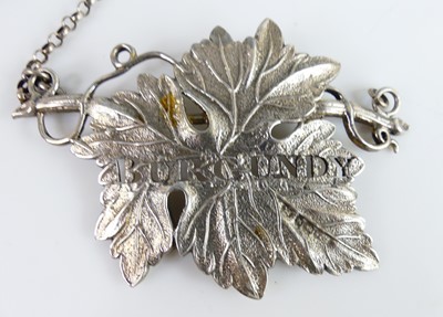 Lot 2102 - A collection of five silver decanter collars,...