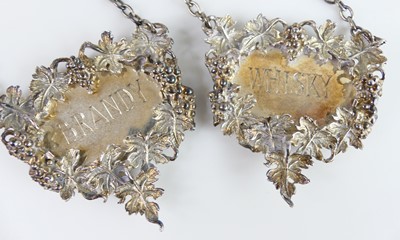 Lot 2102 - A collection of five silver decanter collars,...