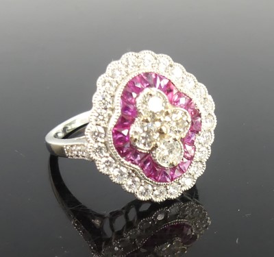 Lot 2357 - A white metal ruby and diamond oblong cluster...