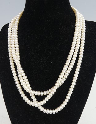 Lot 2244 - A three-row freshwater pearl necklace, the...