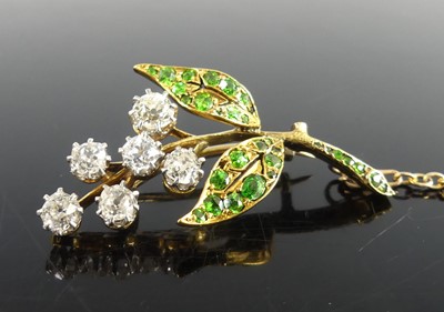 Lot 2236 - A yellow metal diamond and garnet floral spray...