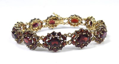 Lot 2531 - A new 9ct yellow gold garnet set bracelet,...