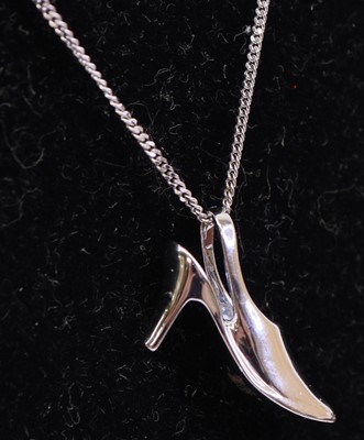 Lot 285 - A 9ct white gold diamond highlight set pendant...