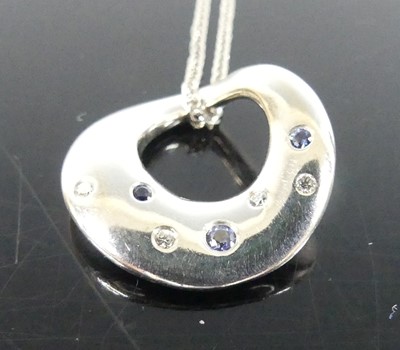 Lot 2302 - An 18ct white gold diamond and sapphire set...