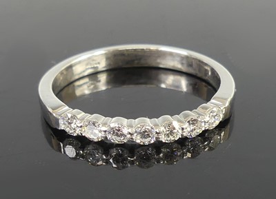 Lot 2647 - A platinum diamond half eternity ring,...