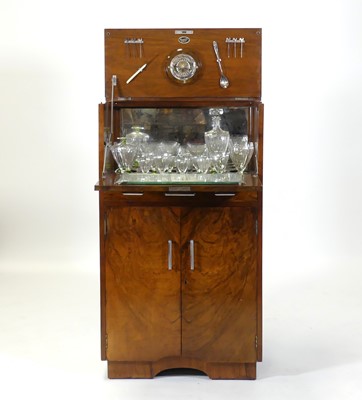 Lot 405 - An Art Deco figured walnut cocktail cabinet,...
