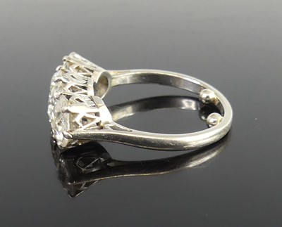 Lot 2359 - A platinum diamond set trilogy ring, arranged...