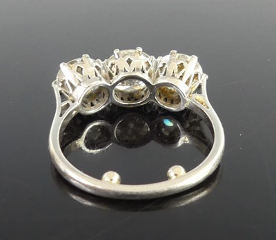 Lot 2359 - A platinum diamond set trilogy ring, arranged...