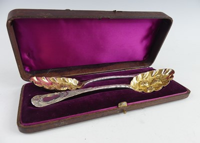 Lot 2154 - A pair of George III silver berry spoons, in...