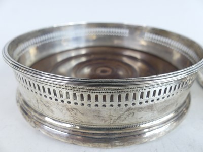 Lot 2109 - A pair of George III silver wine bottle...