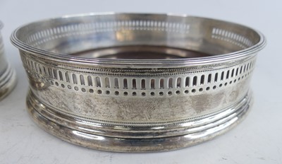 Lot 2109 - A pair of George III silver wine bottle...