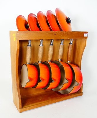 Lot 79 - A graduated set of five Le Creuset orange...