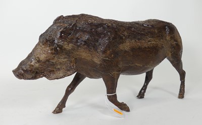 Lot 105 - A carved wooden figure of a warthog, modelled...