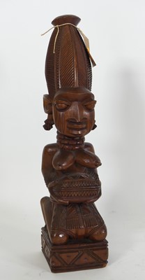Lot 125 - An African carved hardwood fertility figure,...