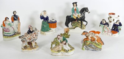 Lot 160 - A group of seven Staffordshire pottery figures,...