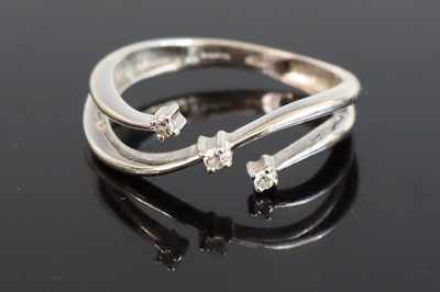 Lot 304 - A white metal diamond dress ring, arranged as...