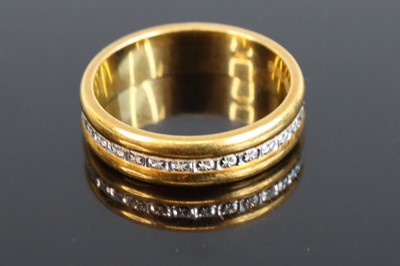 Lot 306 - A modern 18ct gold band ring, centre set with...