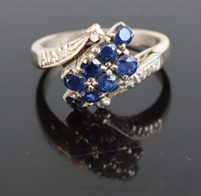 Lot 309 - A white metal sapphire dress ring, arranged as...
