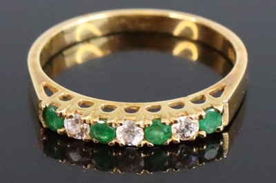 Lot 310 - A modern yellow metal emerald and diamond set...