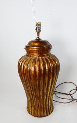 Lot 18 - A contemporary gilt decorated pottery table...