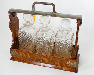 Lot 42 - An Edwardian metal mounted oak tantalus...