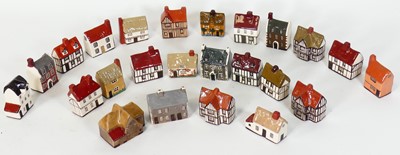 Lot 55 - A collection of Mudlen pottery model cottages