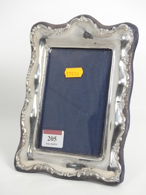 Lot 205 - An Edwardian silver clad easel photograph...