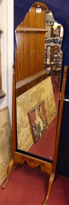 Lot 1101 - A 1930s figured walnut framed cheval mirror,...