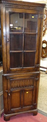Lot 1124 - A contemporary joined oak corner cupboard,...