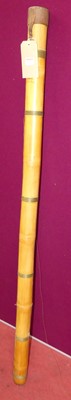 Lot 1162 - A bamboo and tan leather capped fishing rod...