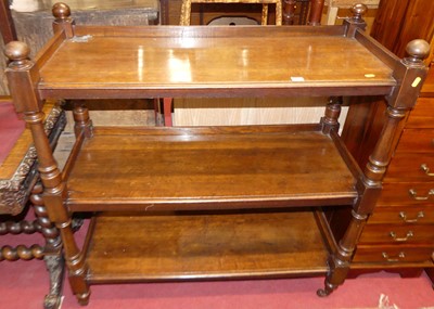 Lot 1185 - A Victorian oak three-tier buffet, raised on...