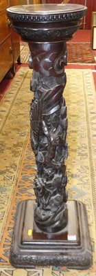 Lot 1189 - An Eastern stained and relief carved hardwood...