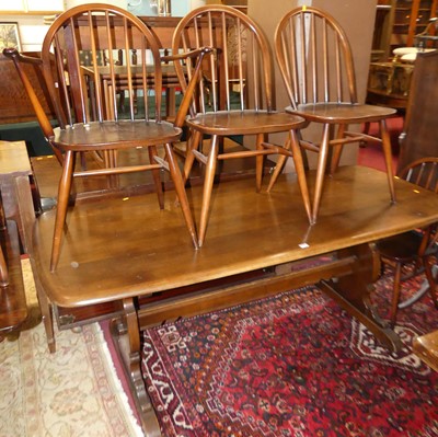 Lot 1269 - An Ercol dark elm and beech dining suite,...