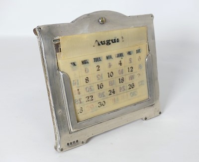 Lot 241 - A George V silver clad desk calendar, with...
