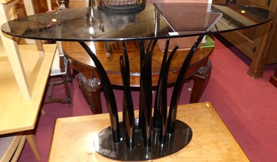 Lot 1304 - A contemporary smoky glass elliptical topped...
