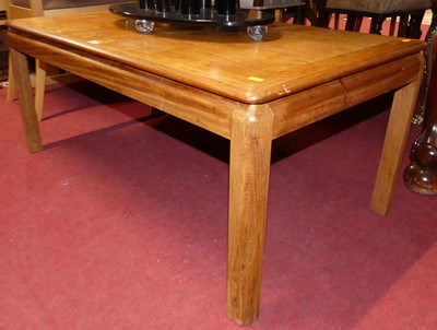 Lot 1305 - A 1980s teak coffee table, length 106cm