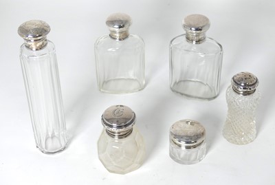 Lot 283 - A near-pair of cut glass scent bottles, having...