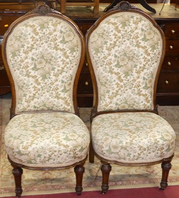 Lot 1334 - A pair of mid-Victorian floral carved walnut...