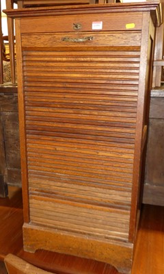Lot 1359 - An early 20th century oak ledgeback tambour...