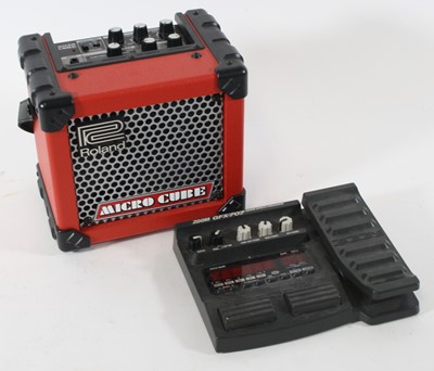 Lot 1418 - A Roland Micro Cube guitar amplifier in red...