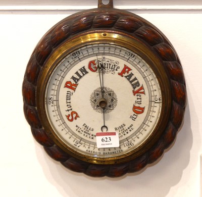 Lot 623 - An oak framed aneroid barometer, height 25 c.m
