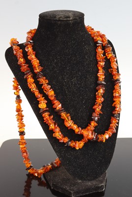 Lot 390 - A faceted orange amber long necklace, 146cm