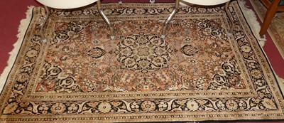 Lot 1130 - A Persian woollen pink and black ground...